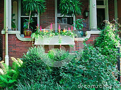 Cute brick front porch with plants and flowers. Editorial Stock Photo