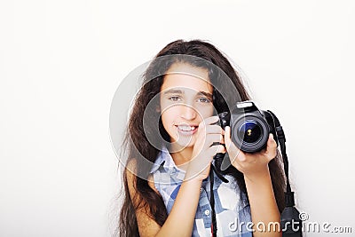 Cute brunette little girl holding an photo camera Stock Photo