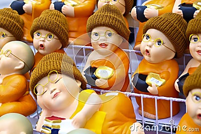 Cute buddhist monk figurines with spectacles and woolly hats Editorial Stock Photo