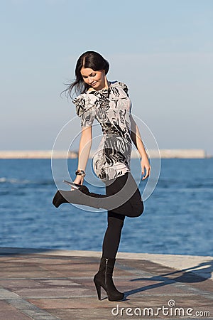 Cute business woman adjusting shoe Stock Photo