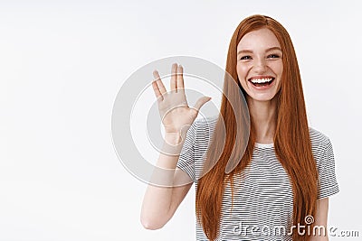 Cute carefree young redhead teenage geek girl like watching tv series fan fantazy movies greet friends raising hand show Stock Photo