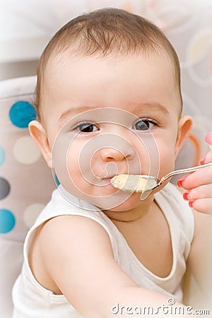 Cute caucasian baby eating Stock Photo