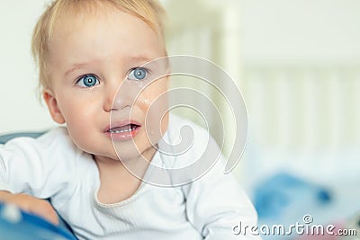 Cute caucasian blond toddler boy portrait crying at home during hysterics. Little child feeling sad. Small pensive baby after Stock Photo