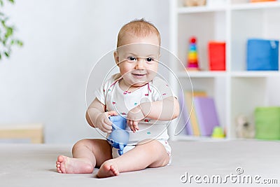 Cute cheerful baby playing with toy at home Stock Photo