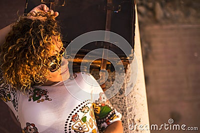 Cute cheerful young lady rest lay down after the trip with an old vintage luggage. travel and vacation enjoy concept for caucasian Stock Photo