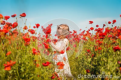 Cute child girl in poppy field gathering flowers. New generation and future. People and sustainable resources. Win Stock Photo