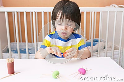Cute child made toothpick legs by playdough spiders Stock Photo