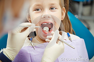 Cute child sits at dentist chair with smile Stock Photo