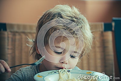 Cute child with spaghetti. Lunch for children. Child with pasta fork Stock Photo
