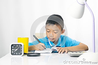 Cute child writing and working on work desk. Stock Photo