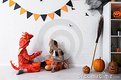 Cute children in costumes trick-or-treating Halloween holiday concept Stock Photo