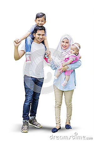 Cute children and parents standing in studio Stock Photo