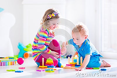 Cute children playing with wooden toys Stock Photo