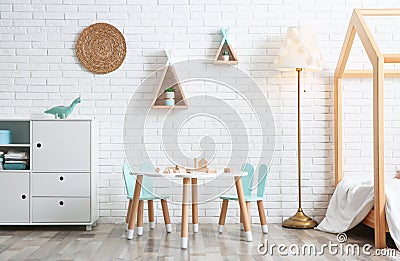 Cute children`s room interior with bed and table Stock Photo