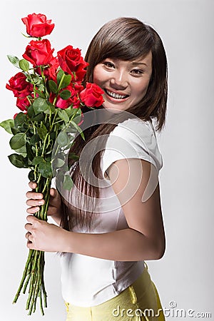 Cute chinese girl happy with roses Stock Photo