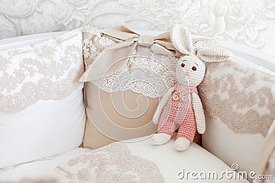 Cute crochet bunny, pink pastel background, handmade rabbit, Easter rabbits, gift, childhood, baby toy Stock Photo