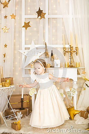 Cute dancing girl in gold decorations Stock Photo