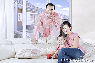 Cute daughter plays toy with parents Stock Photo