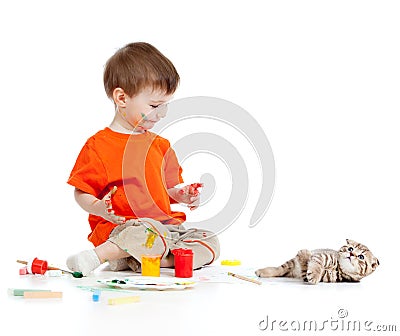 Cute dirty child with paints looking at cat Stock Photo