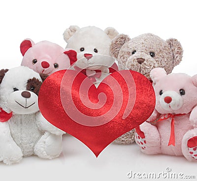 Cute doll with red heart isolated on white. Stock Photo