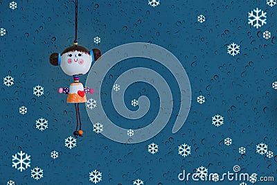 Cute doll and water drop or rain on mirror and snow blue background Stock Photo