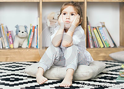 Cute emotional little girl sad about reading books Stock Photo