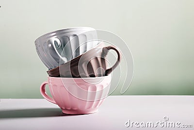 Cute empty ceramic coffee cups pastel colors and rowan branch Stock Photo