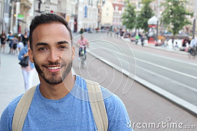 Cute ethnic bearded man smiling outdoors Stock Photo