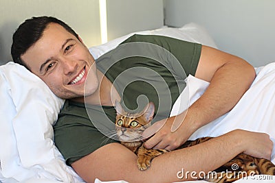 Cute ethnic man sleeping with his cat Stock Photo