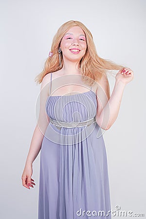 Young mix race happy adult woman in a grey long shiffon evening wear Stock Photo