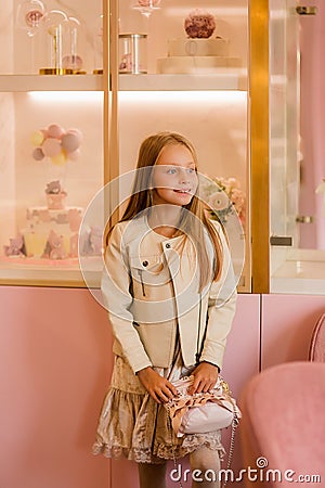 Cute fashionable girl beautifully dressed with a small handbag. shopping concept of modernity Stock Photo