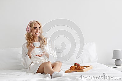Cute female model in pink pajama enjoying morning Stock Photo