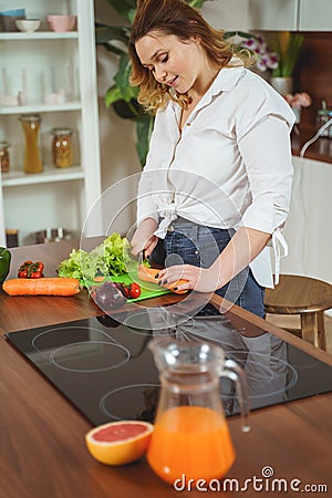 Cute female person spending her morning in the kitchen Stock Photo