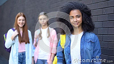 Cute female pupils smiling camera, friendly atmosphere, college campus education Stock Photo