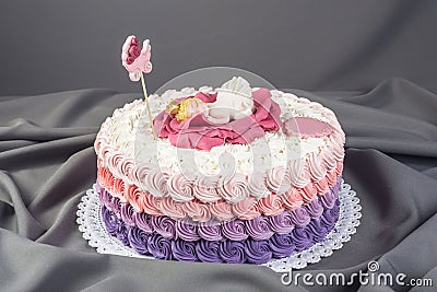 Cute festive pink cake decorated with a big flower where sleeps the little Princess. Desserts for a birthday Stock Photo