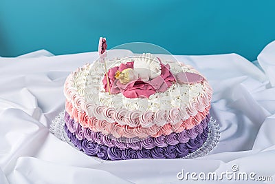 Cute festive pink cake decorated with a big flower where sleeps the little Princess. Desserts for a birthday Stock Photo