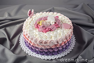 Cute festive pink cake decorated with a big flower where sleeps the little Princess. Desserts for a birthday Stock Photo