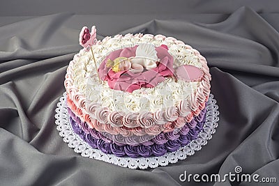 Cute festive pink cake decorated with a big flower where sleeps the little Princess. Desserts for a birthday Stock Photo