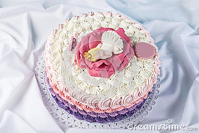 Cute festive pink cake decorated with a big flower where sleeps the little Princess. Desserts for a birthday Stock Photo