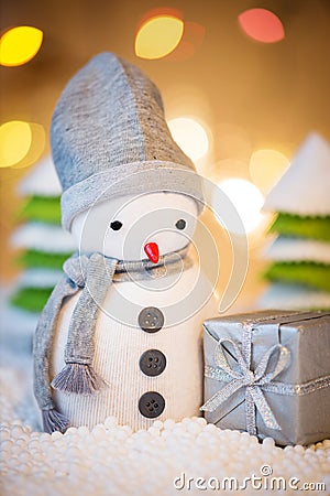 Cute festive snowman with Christmas present Stock Photo