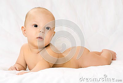 Cute four months old baby on the white sofa Stock Photo