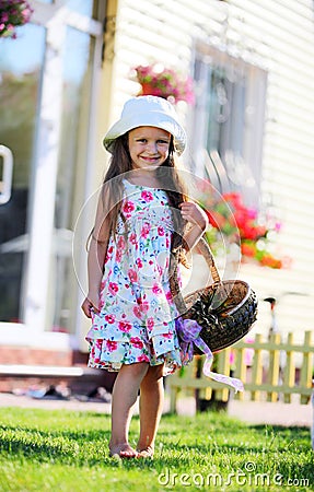 Cute four-year girl carrying a basket Stock Photo