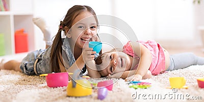 Cute funny children playing with dishware toys at home Stock Photo