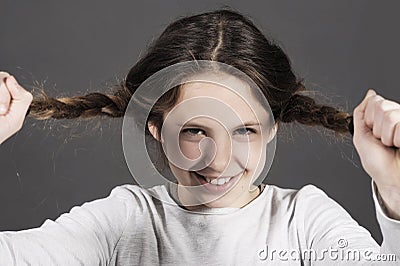 Cute funny girl tears her hair with a huge smile Stock Photo