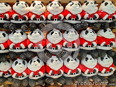 Cute and funny panda in Santa Claus clothes Cute and funny kids toys on shelf in store Stock Photo