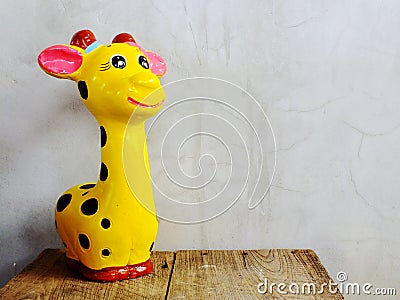 giraffe statue ceramic with space copy on wooden background Stock Photo