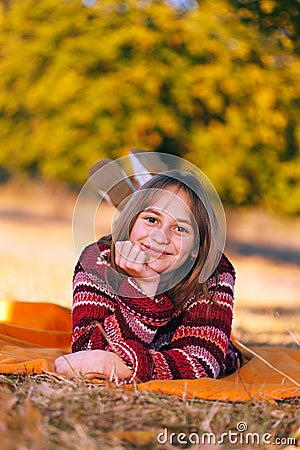 Cute girl in autumn, laying outdoors Stock Photo