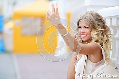 Cute girl with a backpack in the hands of looks in the mirror Stock Photo