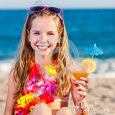 Cute girl on beach holding fruit cocktail. Stock Photo