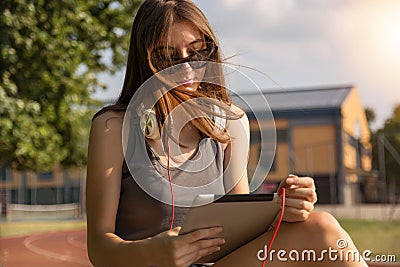Breezy Learning: Cute Girl Engrossed in Education Amidst Park Serenity Stock Photo